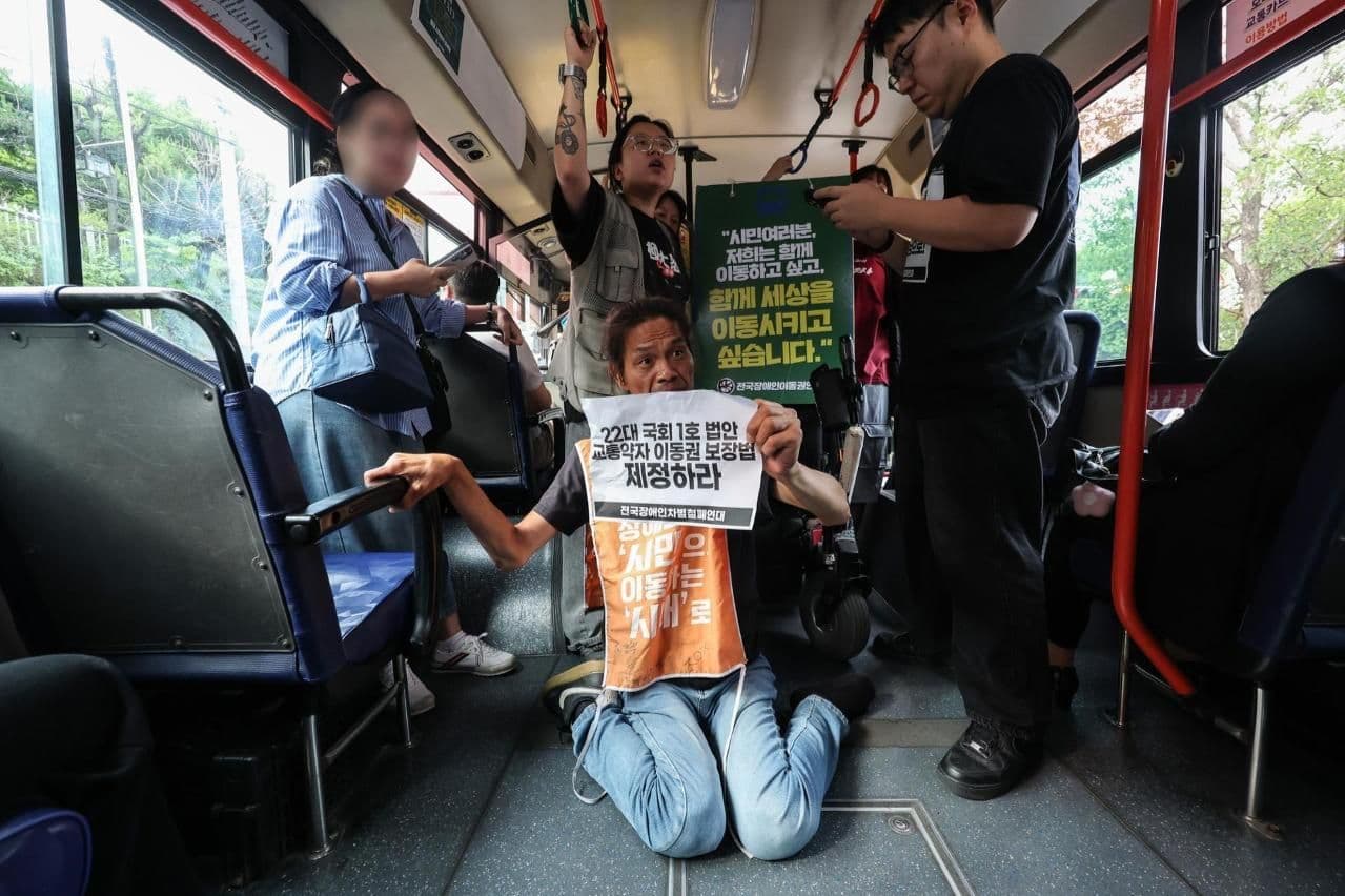 Disability rights activists halt commuter buses, drawing mixed public reactions